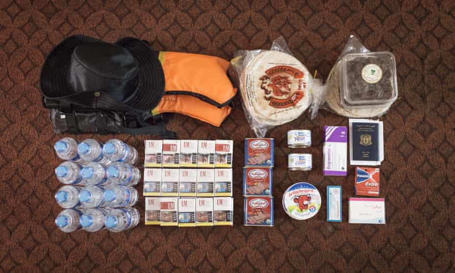 A Syrian refugee’s belongings: bread, cigarettes, medicine, canned meat and cheese, dates, water and ID papers.