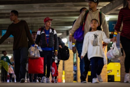 people walk in a bus station