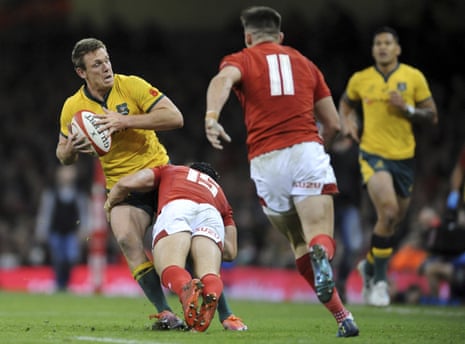 Australia’s Dane Haylett-Petty looks for support as he is tackled by Wales Leigh Halfpenny.
