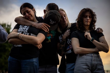 four people with arms around each other four people with arms around each other