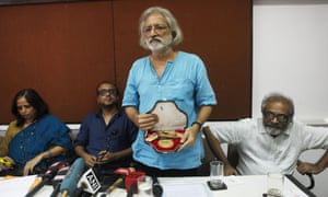 Film-maker Anand Patwardhan shows his national award which he is returning, protesting impediments to freedom of speech.