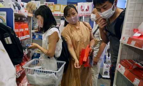 People shop at an official Olympics merchandise shop in Tokyo