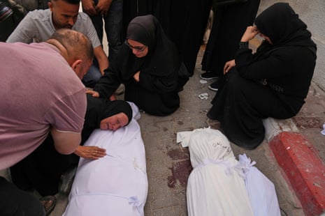 Hanan Al-Aloul mourns over the body of a relative, who was killed when an Israeli army strike hit their home, during the funeral outside al-Shifa hospital in Gaza City. The picture was taken on 18 May 2025.