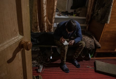 A Ukrainian soldier writes a Christmas wish list upon our request in a base in Donbas during the days before Christmas