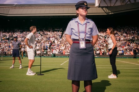 A member of the armed services provides security on court as a player addresses the crowd
