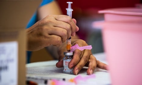 A medical staff member gets vials of the Moderna vaccine against Covid-19 ready at the Corona high school in Corona, east of Los Angeles, California.