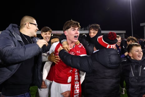 Winning penalty taker Conor Haughey celebrates with fans.