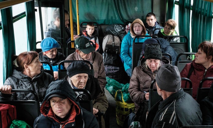 People from the frontline city of Kupiansk wait in a bus to evacuate in Shevchenkove, Kharkiv region.