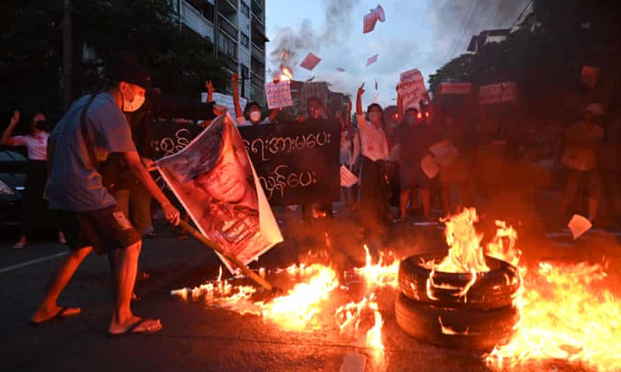 Protesters in Yangon burn a picture of Min Aung Hlaing during a demonstration against the military rule in November 2021.