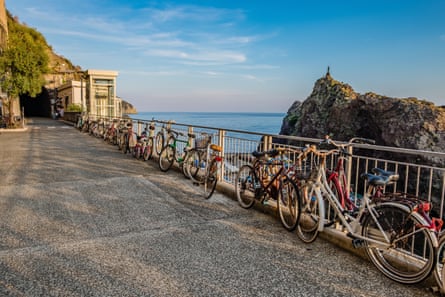 Bikes leaning on railings with a beautiful view of the Med.