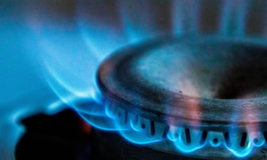 A blue flame emits from a gas cooker.