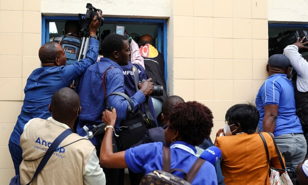 Members of the media jostle for space as President João Lourenço casts his vote in Angola’s election in Luanda on Wednesday. 