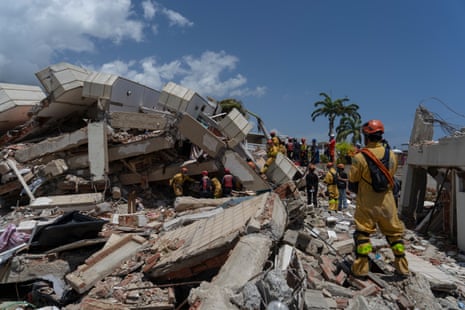 International USAR teams from Brazil, Ecuador and the UK comb through the rubble of collapsed building, La Gabarra, in La Guaira, Venezuela