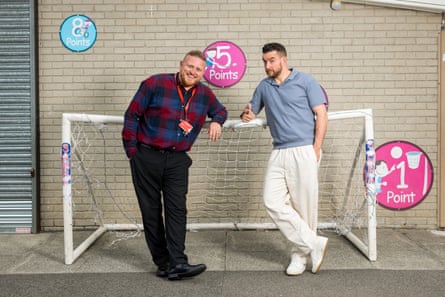 Adam and Lee Parkinson pose by a goalposts in the playground.