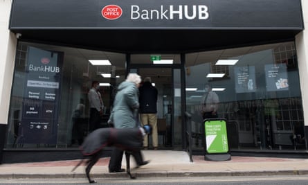 A pedestrian and her dog outside the banking hub in Rochford, Essex