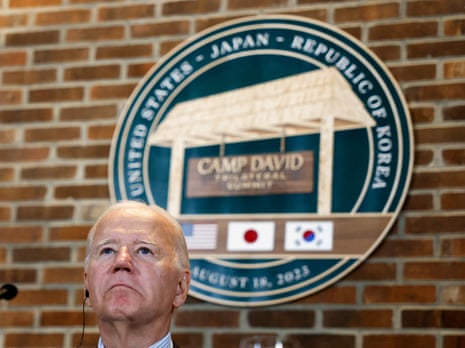Biden looks on as he attends a trilateral summit at Camp David.