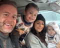 Police inspector Joel Brady and his family smile together inside a car