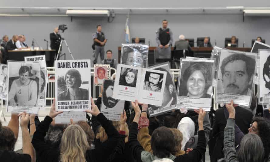 People hold portraits of missing relatives in 2010.