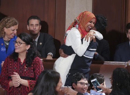 Ilhan Omar embraces her son after she was sworn in by Nancy Pelosi.