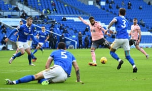 Jayden Bogle takes the deflected shot that gave 10-man Sheffield United the lead at Brighton
