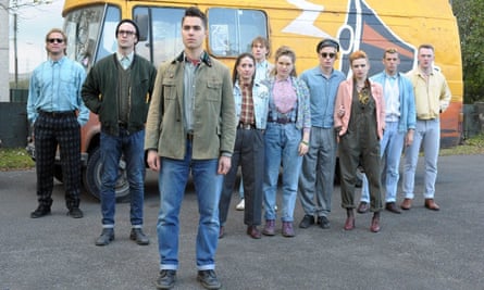 A group of people standing in front of a bus.