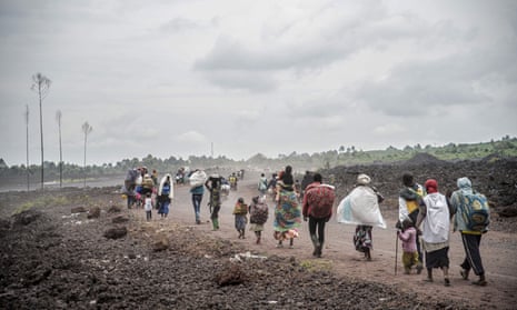 People flee fighting between Congolese forces and M23 rebels near Kibumba, north of Goma.