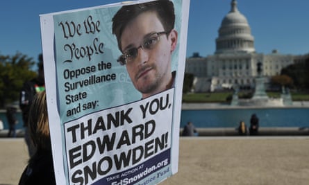 Demonstrators hold placards supporting Snowden during a 2013 protest against government surveillance in Washington, DC.