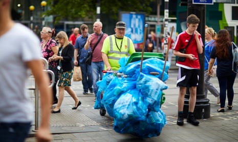 A refuse collector working in Piccadilly Gardens, Manchester