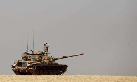 Turkish soldiers on their tank as they prepare for a military operation at the Syrian border against Islamic State.