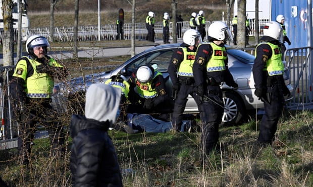 Police detain a person who drove a car into roadblocks near a demonstration in Malmö.