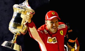 Race winner Sebastian Vettel celebrates on the podium.