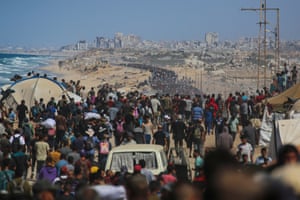 A large number of people walking along a road