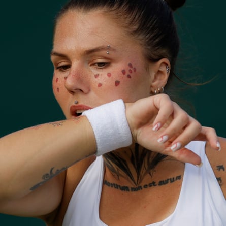 Oleksandra Oliynykova wipes her face, which is covered in strawberry stickers
