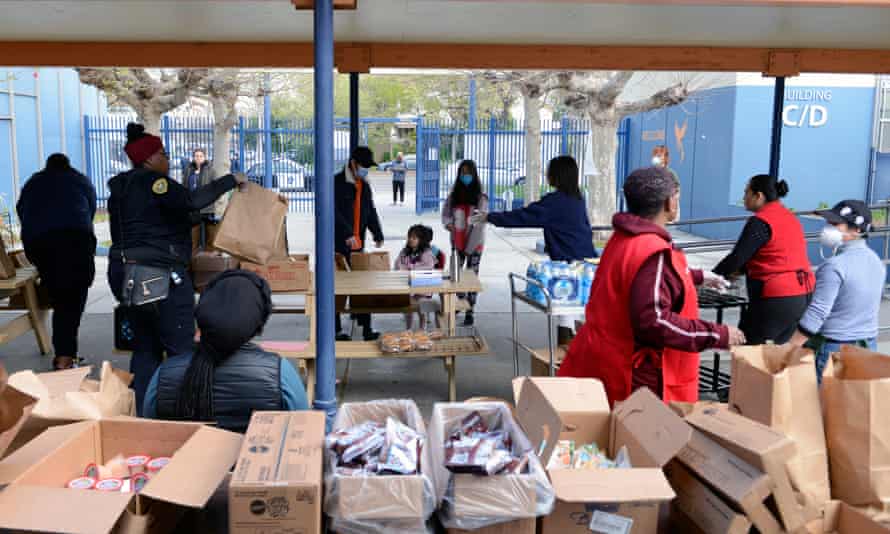Families arrive at West Oakland middle school to pick up grab and go meals during the Oakland unified school district shutdown.