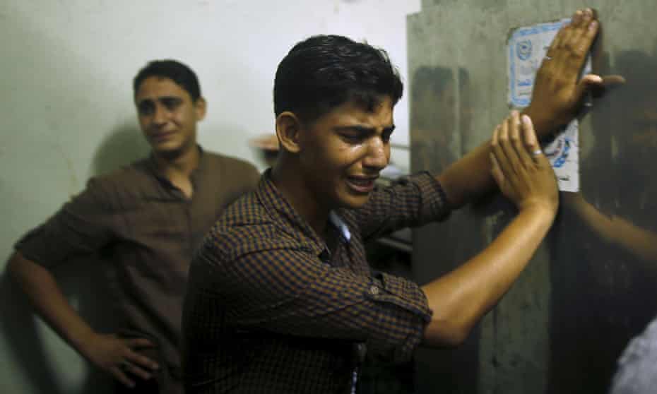 Friends of Mohammed Al-Masri mourn at a morgue in northern Gaza Strip.