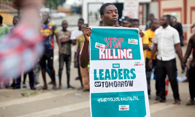 A protester holds a banner that says ‘Stop killing the leaders of tomorrow’ in Lagos
