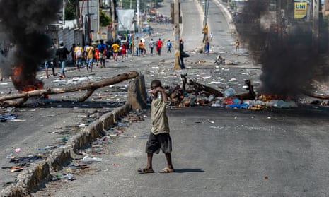 A child is seen in the street as Haitians participate in a protest rejecting foreign military intervention and demanding the resignation of Prime Minister Ariel Henry, in Port-au-Prince, Haiti, 17 October 2022.