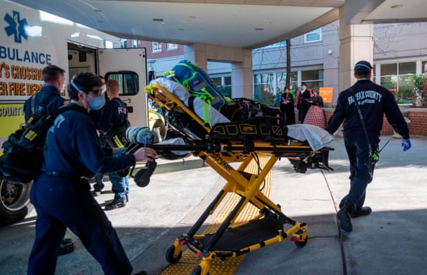 paramedics walk into a senior living community center in Arlington, Virginia, as the US battles coronavirus