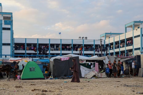 Internally displaced people are seen at a temporary shelter in the southern Gaza Strip city of Khan Younis.