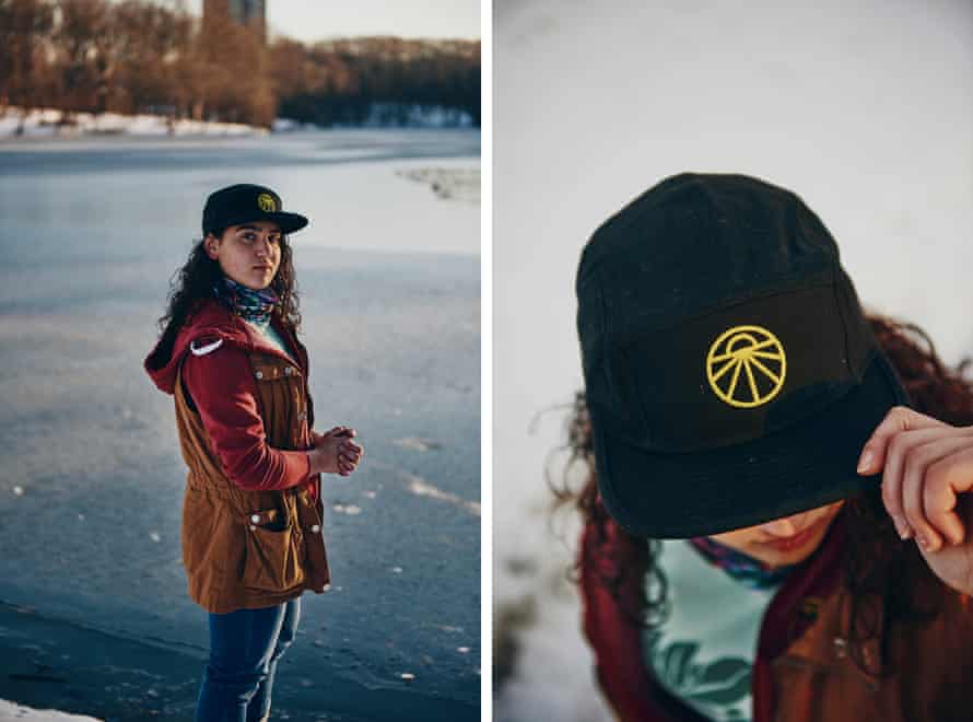 Saya Ameli’s hat which has the “Sunrise Movement” logo which is about pursuing the green new deal. Saya Ameli is wearing her hat at Leverett Pond in Brookline, Massachusetts. Credit: Tony Luong for The Guardian