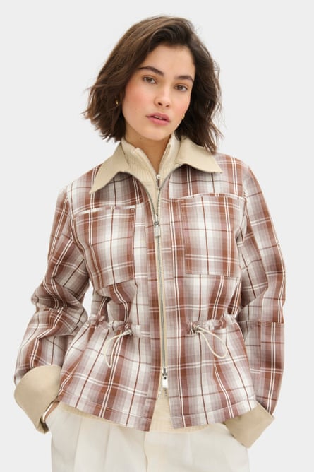 A model wearing a plaid jacket