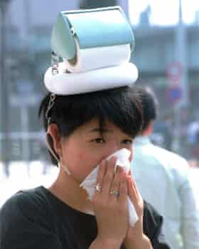 A woman wearing a “hay fever hat” created by the Japanese inventor Kenji Kawakami.