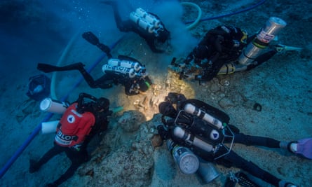 The team examining the bone find. The bones likely survived because the ship sank fast into the cool depths and was buried by a mound of silt that slid down the cliff after the vessel.