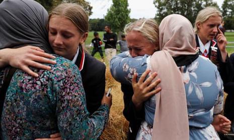 High school students from a Christian school embrace Muslims waiting for news of their relatives at a community centre, following Friday’s shooting in Christchurch.