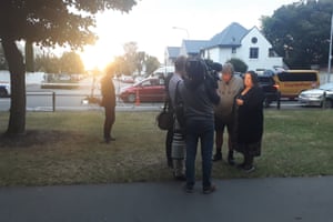 New Zealanders are beginning to arrive with flowers and tributes as dusk falls on Christchurch. “New Zealand is with you.” said a woman who dropped off lillies. “New Zealand stands by you”