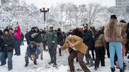People participate successful a wide snowball conflict during a wintertime blizzard connected 23 February successful New York City.