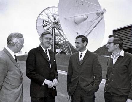 Prime Minister Gorton (second left) and Tom Reid (right) pose in front of the Honeysuckle dish, which has been moved out of tracking alignment for this photo.