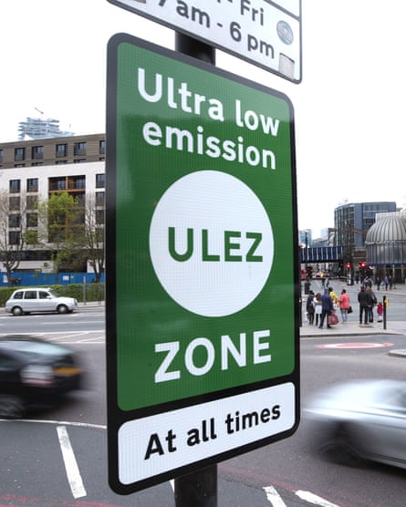 A green road sign saying 'Ultra low emission (Ulez) zone – at all times'