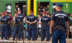 Hungarian police stop a train with refugees in Bicske.