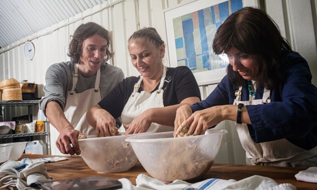 Sarah (not her real name), centre, and Tahmineh Gashtasebi being taught baking skills by Jean Kern, left, at the E5 Bakehouse in London Fields